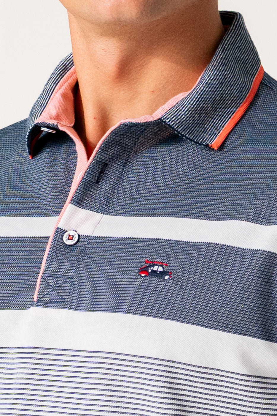 Polo de rayas marino y blanco con detalles en coral